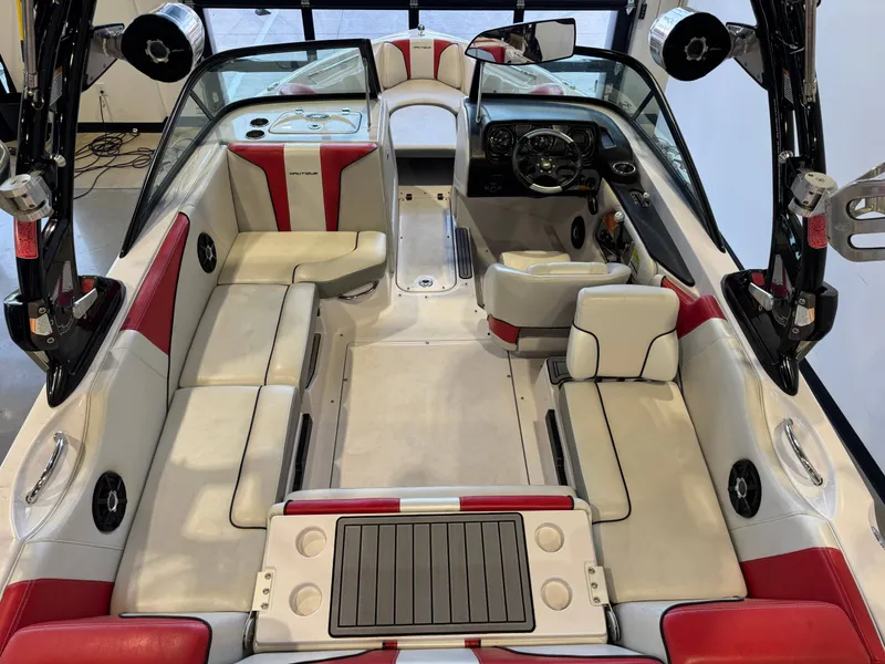 Slide: The Image of Interior of a 2011 Nautique Super Air Nautique 210 with red and white seating. - 12