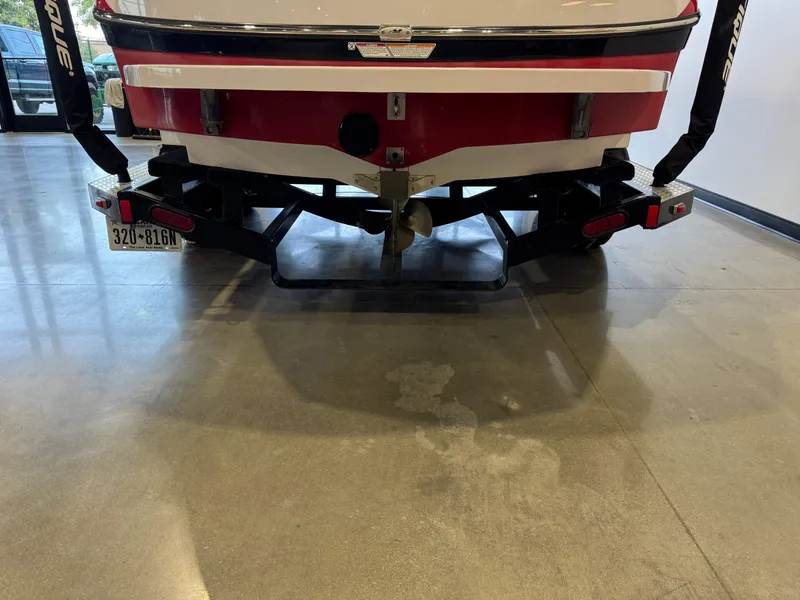 Slide: The Image of The image shows the rear of a 2011 Nautique Super Air Nautique 210 boat on a trailer. - 7