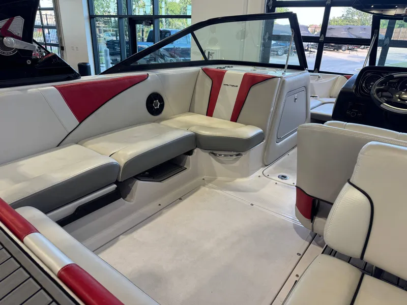 Slide: The Image of Interior of a 2011 Nautique Super Air Nautique 210 with white and red seating. - 13