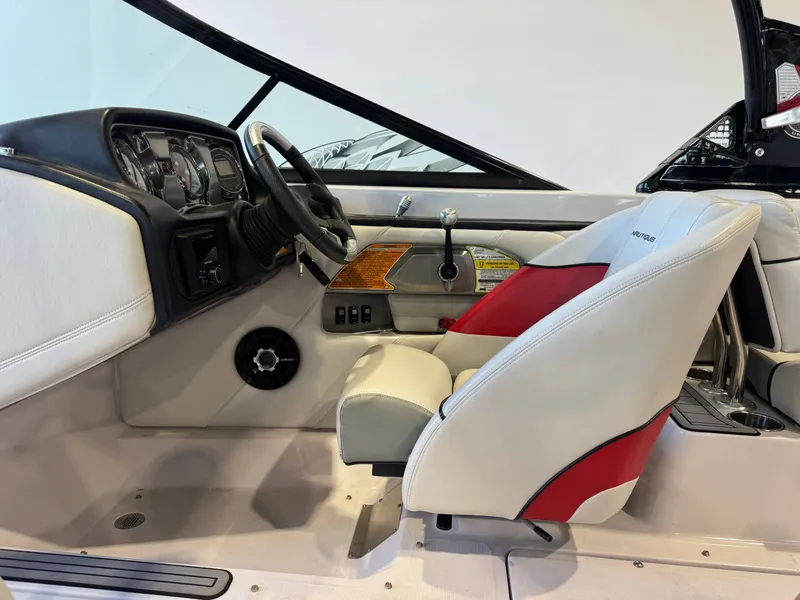 Slide: The Image of Interior of a 2011 Nautique Super Air Nautique 210 with white and red seating and dashboard. - 22