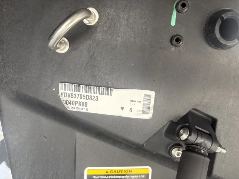 Slide: The Image of Close-up of a boat part with serial number and caution label. - 25