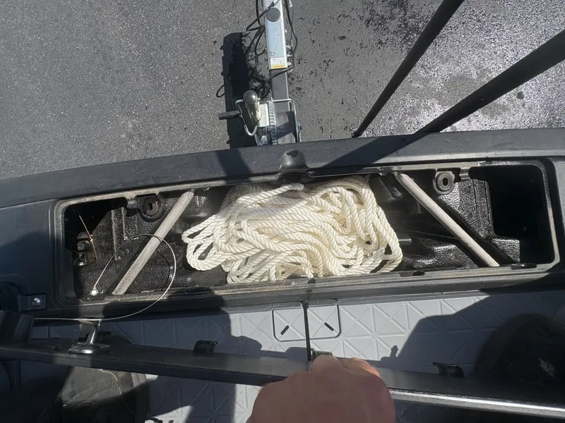 Slide: The Image of A rope is stored in a compartment of a Sea-Doo Switch Cruise 21 boat. - 22