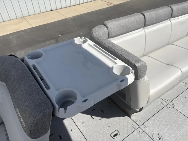 Slide: The Image of The image shows a gray seating area with a foldable table on a boat. - 19