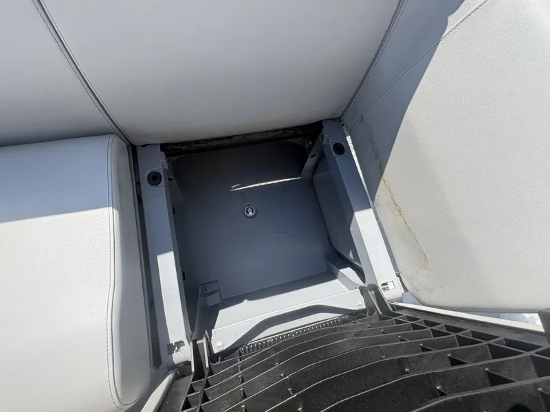 Slide: The Image of An empty storage compartment under a seat on a Sea-Doo Switch Cruise 21 boat. - 20