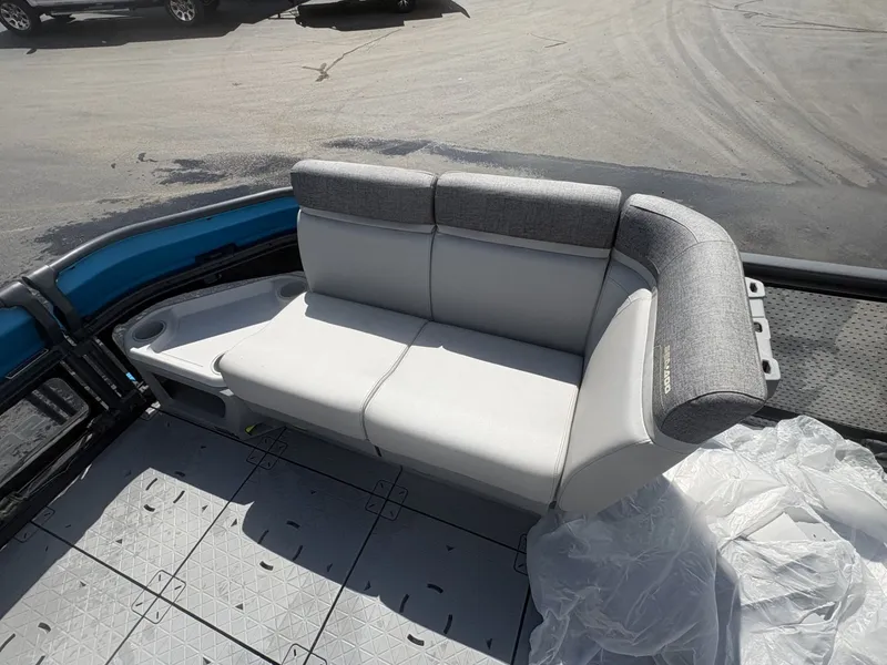 Slide: The Image of The image shows a gray bench seat on a boat, surrounded by a textured floor surface. - 14