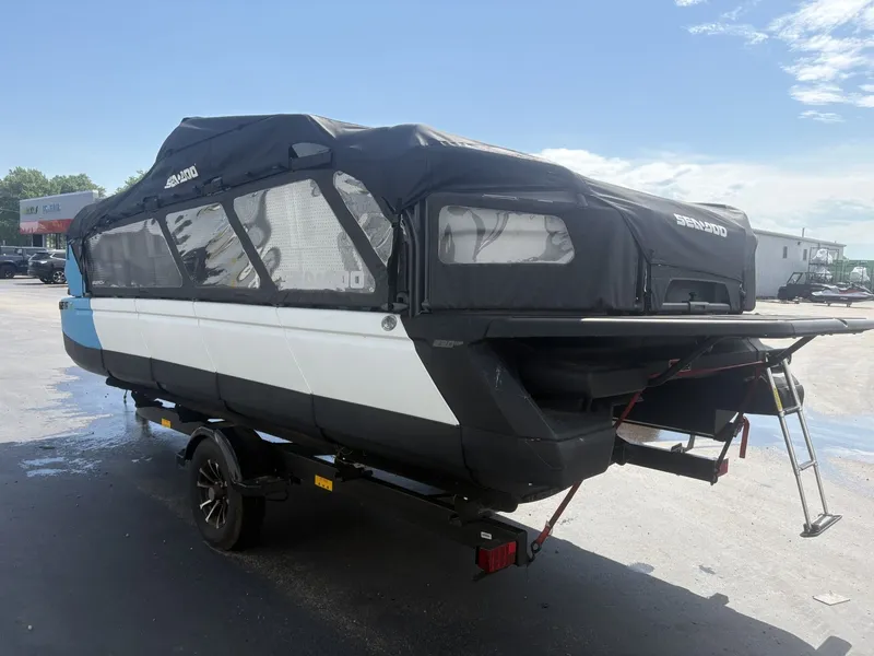 Slide: The Image of A 2023 Sea-Doo Switch Cruise 21 on a trailer, featuring a black canopy and ladder. - 3