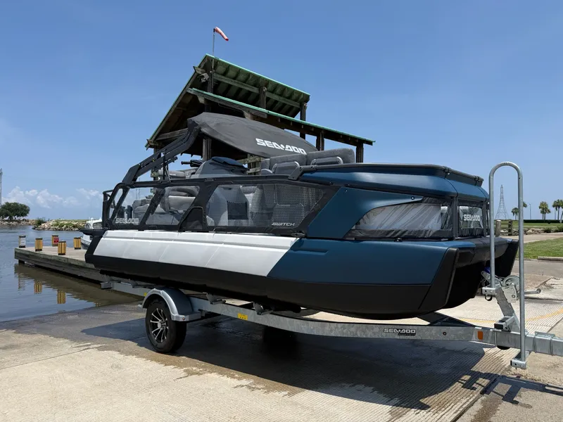 The Image of A 2026 Sea-Doo Switch Cruise 21 on a trailer at a boat ramp. - 1