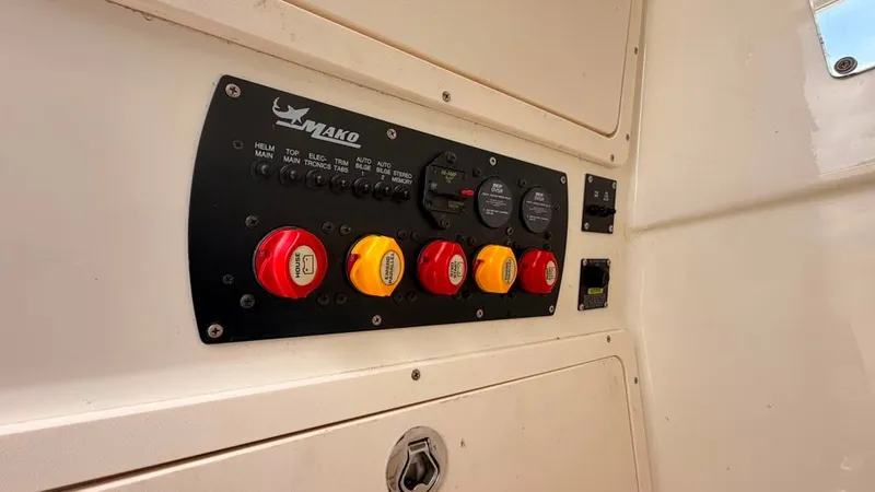 Slide: The Image of Control panel with multiple switches and gauges on a boat. - 26
