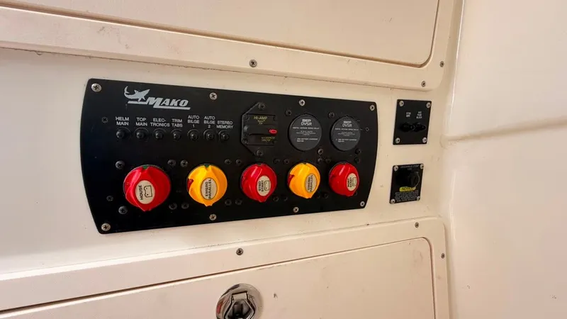 Slide: The Image of Control panel with Mako logo and colored switches on a boat. - 27