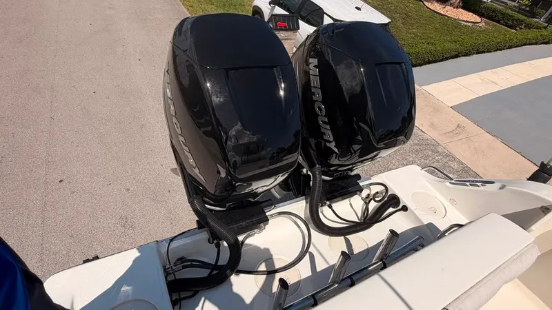 Slide: The Image of Two Mercury outboard engines are mounted on the stern of a Mako 284 Center Console boat. - 12