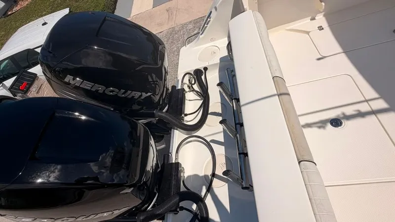 Slide: The Image of Two Mercury outboard engines on a 2015 Mako 284 Center Console boat. - 13
