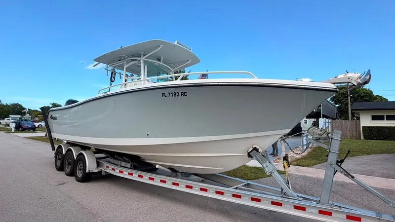 Slide: The Image of A 2015 Mako 284 Center Console boat on a trailer, ready for transport. - 36