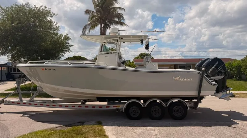 Slide: The Image of A 2015 Mako 284 Center Console boat on a trailer, ready for transport. - 3