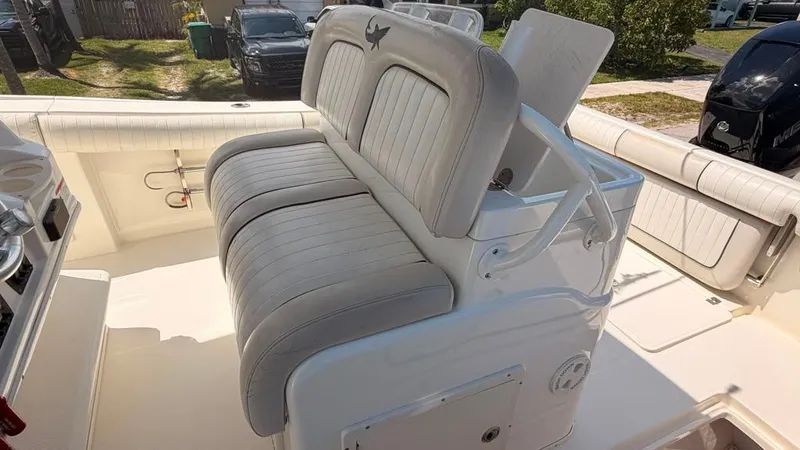 Slide: The Image of Seating area on a 2015 Mako 284 Center Console boat with cushioned seats. - 19