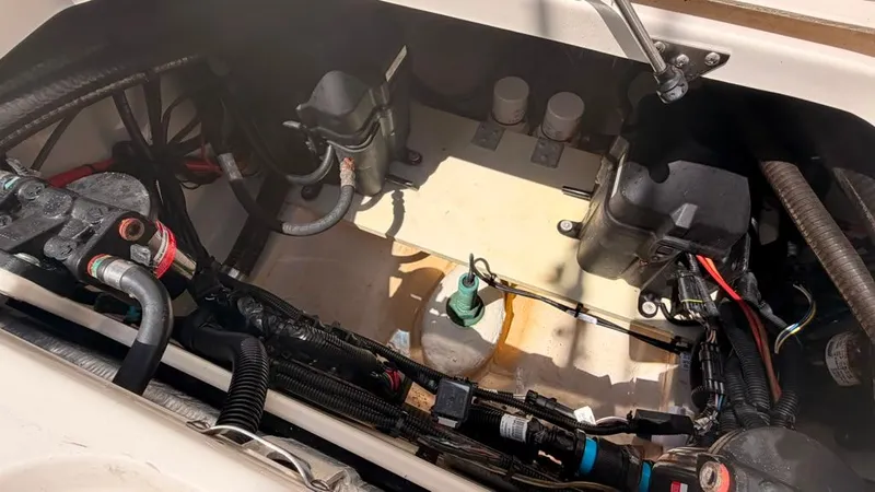 Slide: The Image of A view inside the engine compartment of a 2015 Mako 284 Center Console boat. - 16