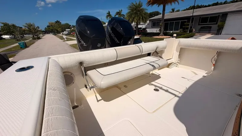 Slide: The Image of 2015 Mako 284 Center Console with twin outboard engines, on a trailer in a residential area. - 30
