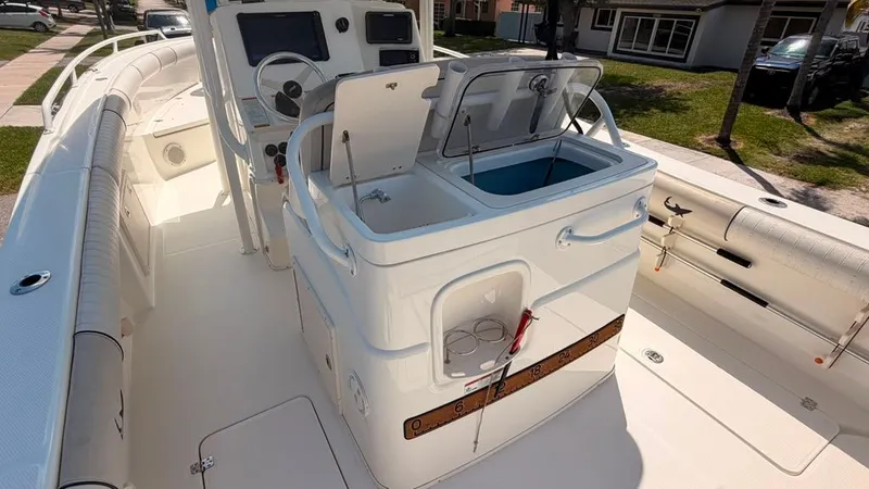 Slide: The Image of The image shows the cockpit of a 2015 Mako 284 Center Console boat. - 15