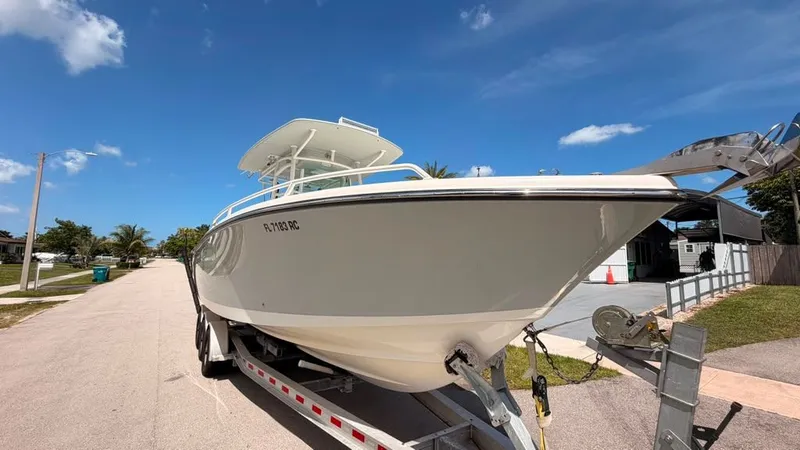 Slide: The Image of A 2015 Mako 284 Center Console boat on a trailer, ready for the water. - 9