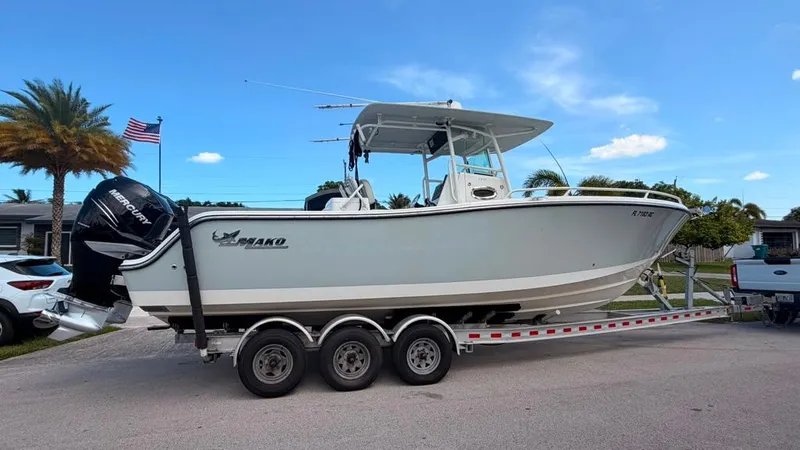 Slide: The Image of A 2015 Mako 284 Center Console boat on a trailer, ready for transport. - 35