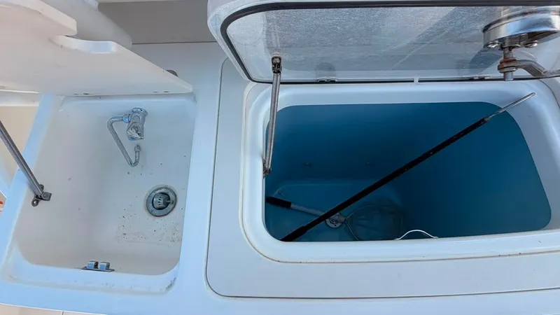 Slide: The Image of An open storage compartment and sink on a boat. - 17