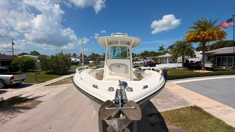 Slide: The Image of A 2015 Mako 284 Center Console boat on a trailer in a residential area. - 11