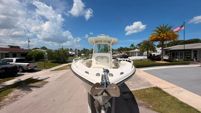 Slide: The Image of A 2015 Mako 284 Center Console boat on a trailer in a residential area. - 10