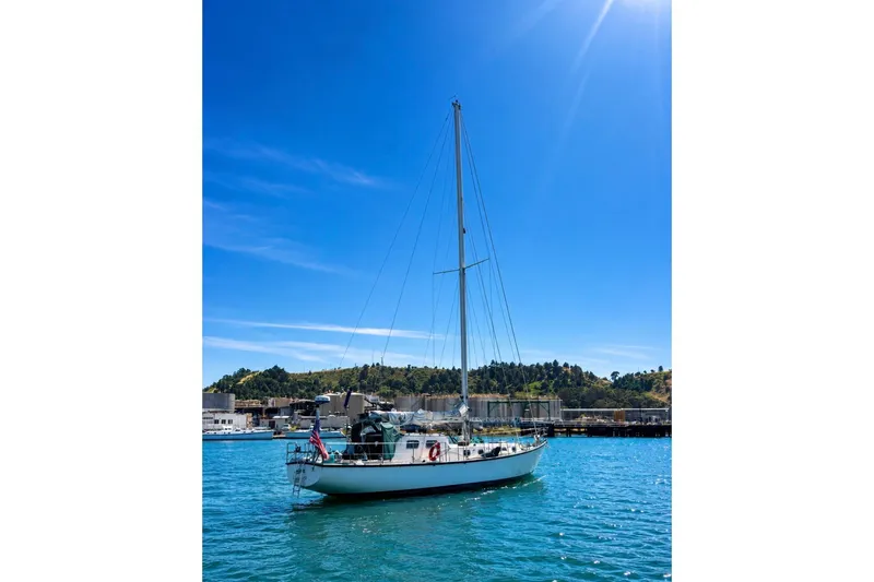 Slide: The Image of Sailboat "Custom Steel Cutter" 1987 on blue water under clear sky. - 2