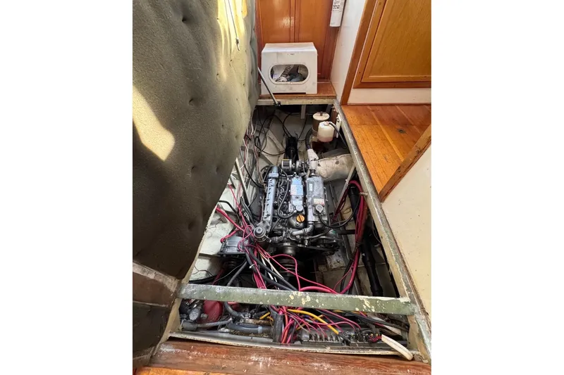 Slide: The Image of Engine compartment of a 1987 Custom Steel Cutter sailboat, showcasing wiring and components. - 8