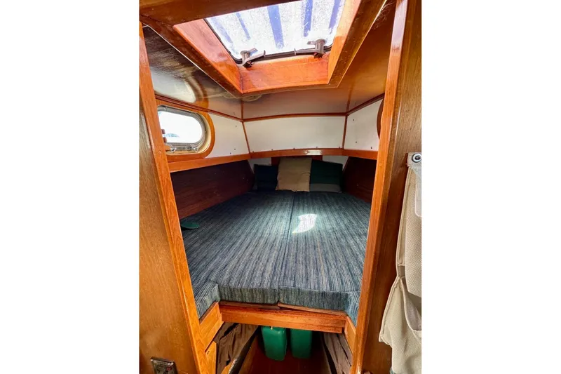 Slide: The Image of Cozy cabin interior of 1987 Custom Steel Cutter sailboat with wooden finish and skylight. - 9