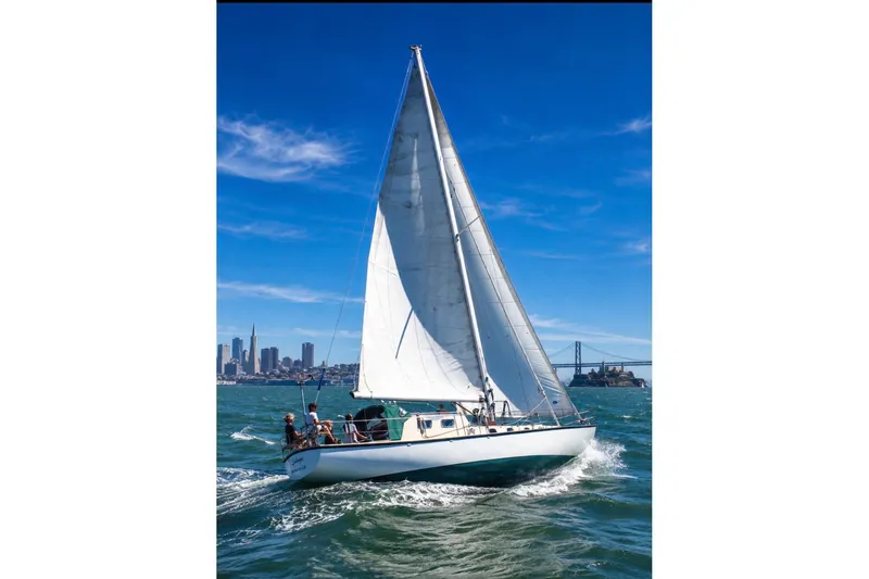 The Image of Sailboat "Custom Steel Cutter" 1987 cruising near city skyline and bridge on sunny day. - 0