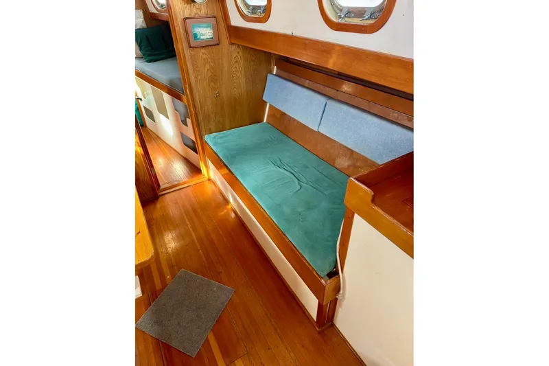 Slide: The Image of Interior of 1987 Custom Steel Cutter with wooden flooring and cushioned seating. - 5