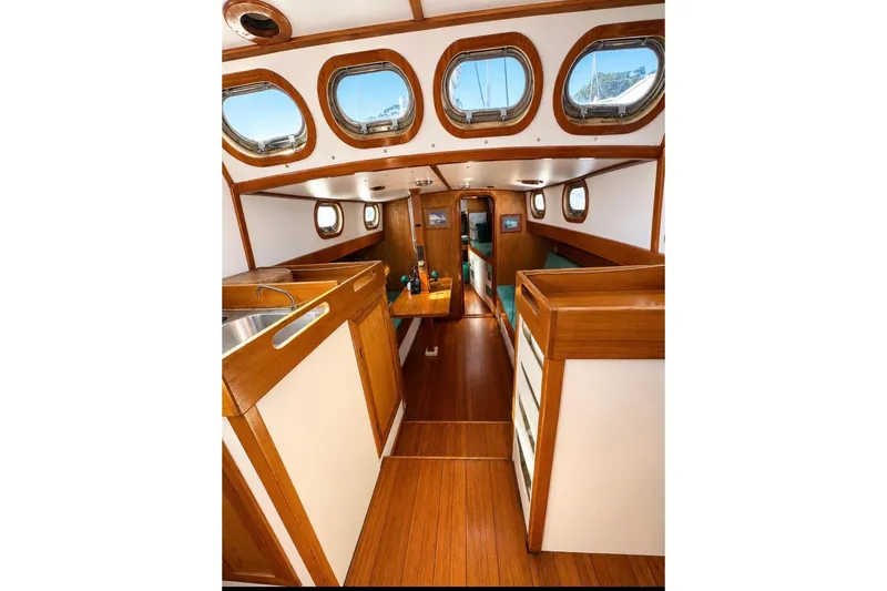 Slide: The Image of Interior of 1987 Custom Steel Cutter sailboat with wood finish and porthole windows. - 3