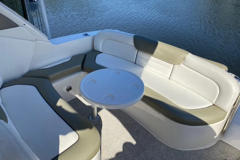 Slide: The Image of 2007 Sea Ray Sundancer 310 boat interior with cushioned seating and round table by the water. - 14