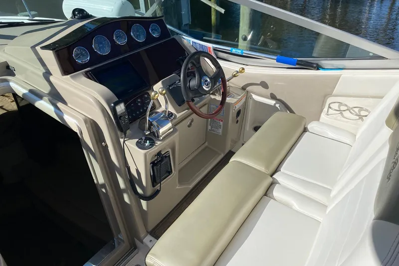 Slide: The Image of 2007 Sea Ray Sundancer 310 cockpit with steering wheel and control panel. - 25