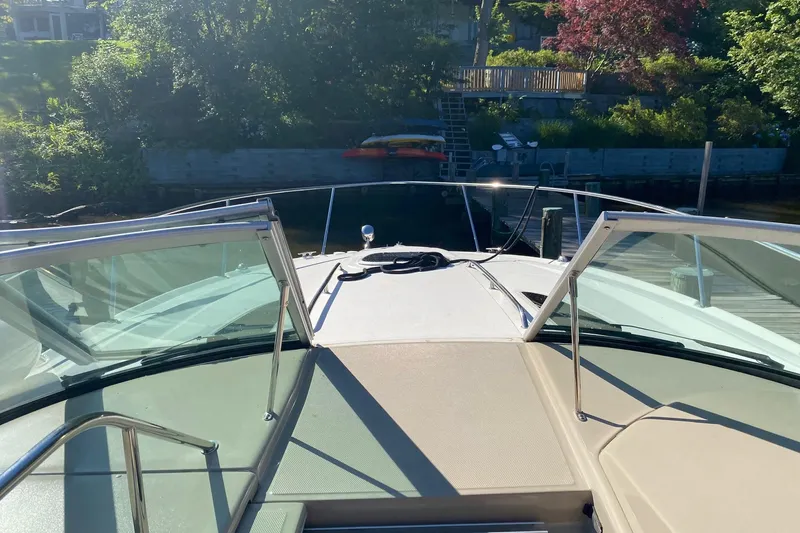 Slide: The Image of 2007 Sea Ray Sundancer 310 boat docked, view from the bow with clear skies. - 24