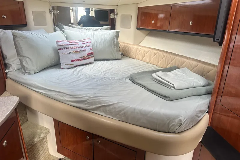 Slide: The Image of Luxurious cabin interior of 2007 Sea Ray Sundancer 310 with cozy bed and elegant wood cabinetry. - 40