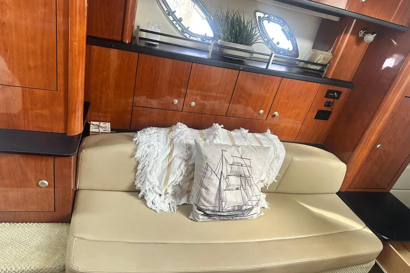Slide: The Image of Interior of 2007 Sea Ray Sundancer 310 with beige seating and nautical-themed decor. - 30