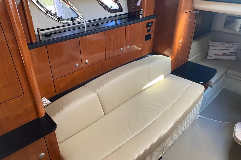 Slide: The Image of Interior of 2007 Sea Ray Sundancer 310 yacht with beige seating and wooden cabinetry. - 31