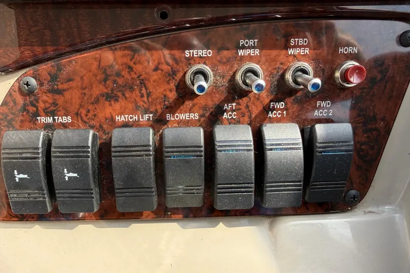 Slide: The Image of Control panel of a 2007 Sea Ray Sundancer 310 boat with switches and buttons. - 21