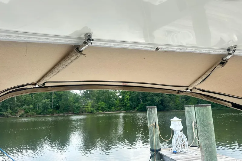 Slide: The Image of 2007 Sea Ray Sundancer 310 canopy view at a serene dockside location. - 16