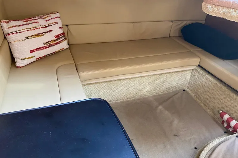 Slide: The Image of Interior of 2007 Sea Ray Sundancer 310 with beige seating and decorative pillow. - 33
