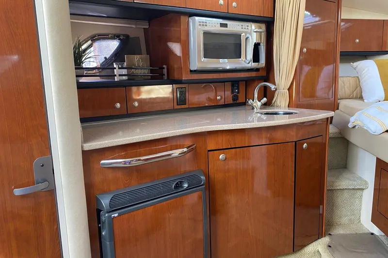 Slide: The Image of Luxurious 2007 Sea Ray Sundancer 310 yacht interior with kitchenette and modern amenities. - 34