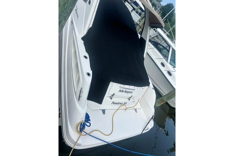 Slide: The Image of A 2007 Sea Ray Sundancer 310 is docked, featuring a black cover. - 9