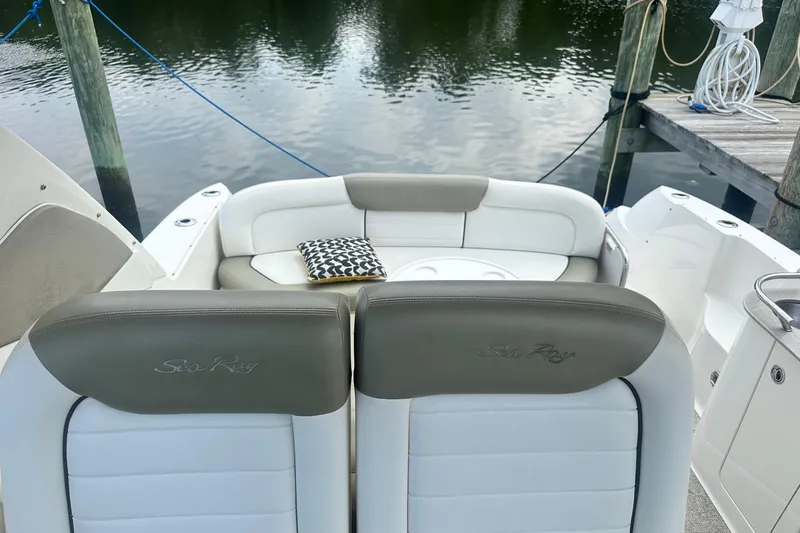 Slide: The Image of 2007 Sea Ray Sundancer 310 boat interior with cushioned seating and decorative pillow. - 12