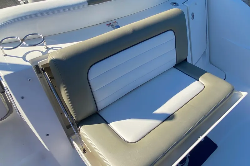 Slide: The Image of 2007 Sea Ray Sundancer 310 boat seat with cup holders, featuring beige and white upholstery. - 6