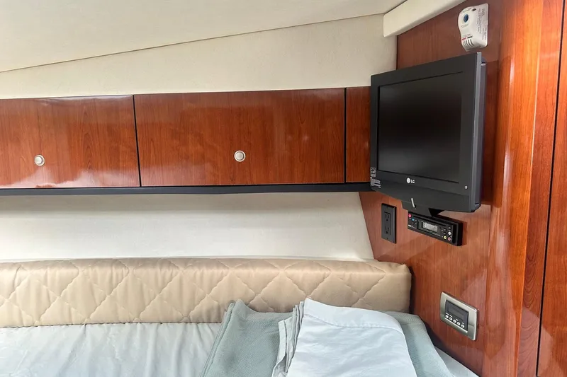 Slide: The Image of Interior of 2007 Sea Ray Sundancer 310 with wood cabinets and mounted TV. - 41