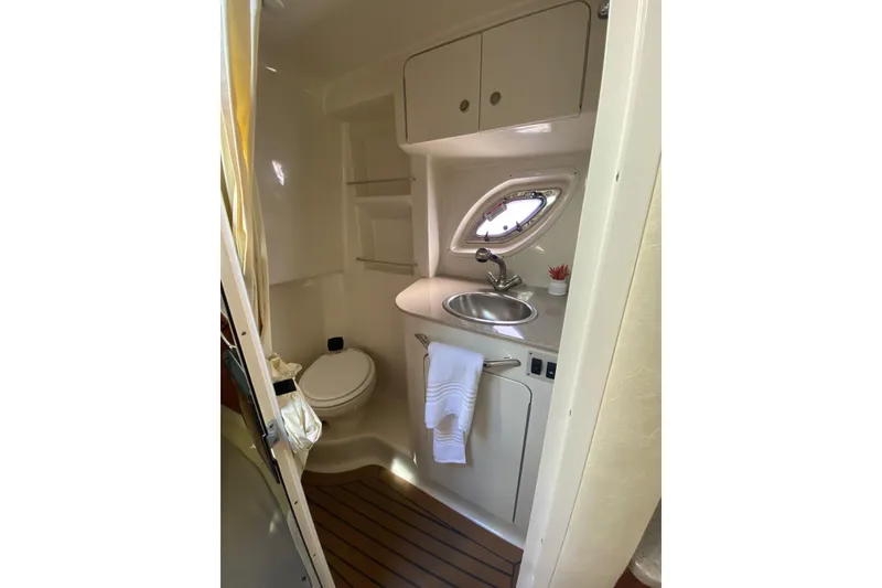 Slide: The Image of 2007 Sea Ray Sundancer 310 bathroom with sink, toilet, and porthole window. - 45