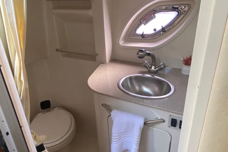 Slide: The Image of 2007 Sea Ray Sundancer 310 bathroom with sink, toilet, and porthole window. - 46