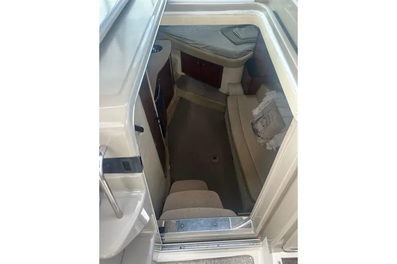 Slide: The Image of Interior cabin of 2007 Sea Ray Sundancer 310, featuring seating and compact design. - 26
