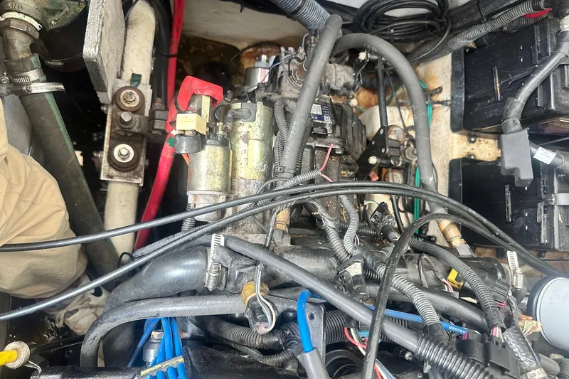 Slide: The Image of Engine compartment of a 2007 Sea Ray Sundancer 310 with visible wiring and components. - 52